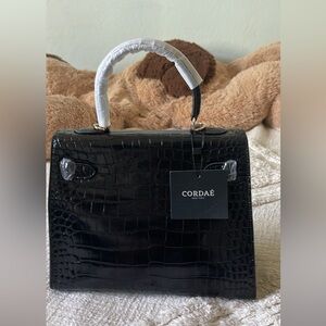 Black leather purse with crocodile print and gold hardware